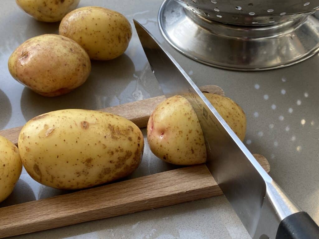 Knife slicing potatoes
