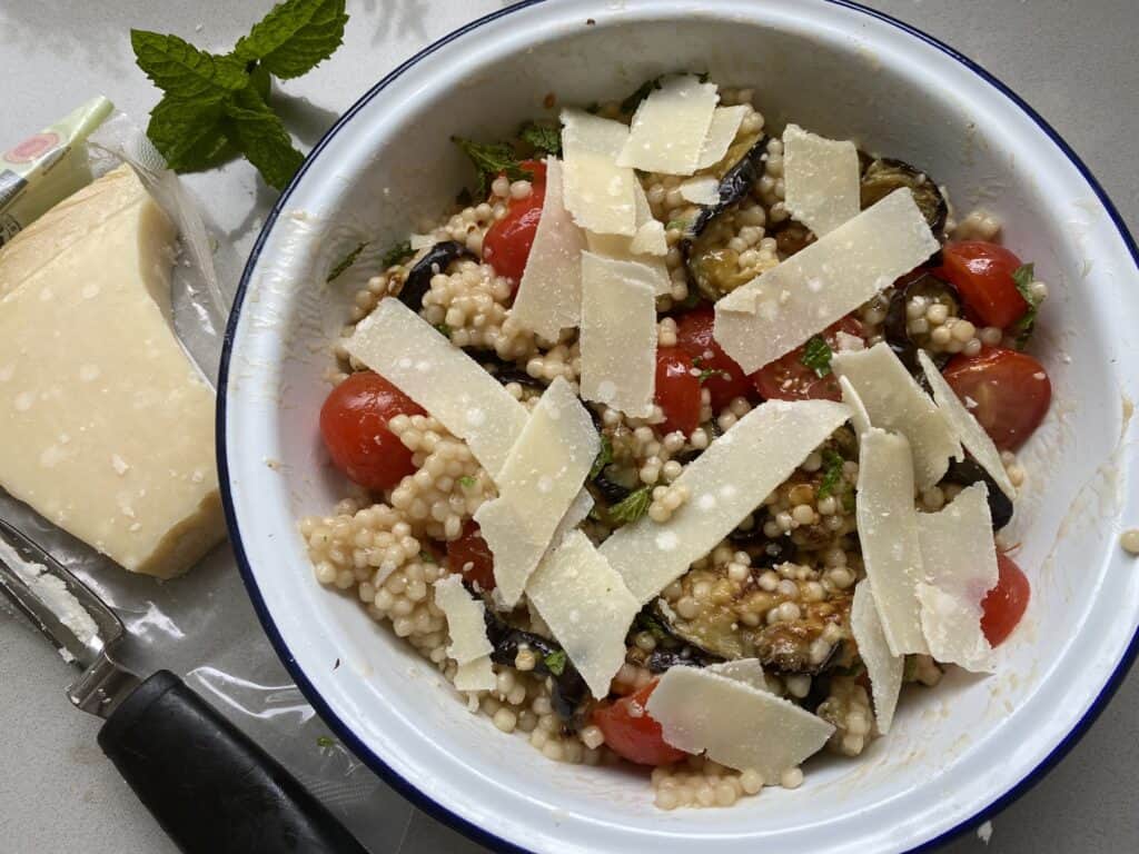 Overheat shot of Aubergine, Tomato and Couscous Salad in a white dish