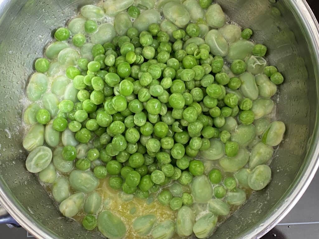 Add the peas to the beans and cook for a further 5 mins